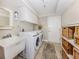 Practical laundry room with washer, dryer, sink, and ample storage space at 1234 Paradise Way, Venice, FL 34285