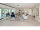 Inviting living room featuring tile flooring, comfortable seating, and sliding glass doors to the outdoor patio area at 1234 Paradise Way, Venice, FL 34285