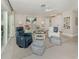 Bright living room features tile floors, comfortable seating, and sliding glass doors that bring the outdoors in at 1234 Paradise Way, Venice, FL 34285