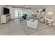 Bright living room boasts tile flooring, comfy seating, and sliding doors to the pool and patio area for seamless indoor-outdoor living at 1234 Paradise Way, Venice, FL 34285