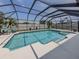 Large screened-in pool featuring a spa, providing a luxurious outdoor retreat at 1234 Paradise Way, Venice, FL 34285