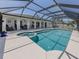 Beautiful backyard pool with screened enclosure offering privacy and protection from the elements at 1234 Paradise Way, Venice, FL 34285
