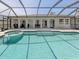 Backyard pool with attached spa and screened enclosure, perfect for relaxation and entertaining at 1234 Paradise Way, Venice, FL 34285