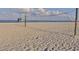 Volleyball net on the beach with a view of the lifeguard stand in the background at 1234 Paradise Way, Venice, FL 34285