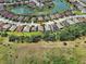 Aerial view of a home and its proximity to a pond and green space at 12728 Richezza Dr, Venice, FL 34293