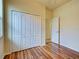 Bedroom features laminate flooring, white trim, and a large closet with bi-fold doors at 12728 Richezza Dr, Venice, FL 34293
