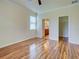 A spacious bedroom showcases wood-look flooring with access to a closet and bathroom at 12728 Richezza Dr, Venice, FL 34293