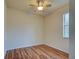 Cozy bedroom with laminate flooring, ceiling fan, and a window bringing in natural light at 12728 Richezza Dr, Venice, FL 34293