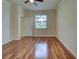 Spacious bedroom with wood-look flooring, ceiling fan, and a sunny window at 12728 Richezza Dr, Venice, FL 34293