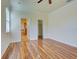 Bedroom with wood-look flooring leading to ensuite bathroom and closet space at 12728 Richezza Dr, Venice, FL 34293