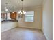 A dining area with tile flooring and modern light fixture at 12728 Richezza Dr, Venice, FL 34293