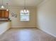 Dining room with tile floors, neutral paint, chandelier, and a large window at 12728 Richezza Dr, Venice, FL 34293