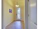 Bright entryway with tiled floor, decorative light fixture, and glass paneled front door at 12728 Richezza Dr, Venice, FL 34293