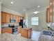 Bright kitchen featuring stainless steel appliances and granite countertops at 12728 Richezza Dr, Venice, FL 34293