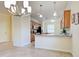 A kitchen featuring tile flooring, wooden cabinets and granite countertops at 12728 Richezza Dr, Venice, FL 34293