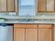 A kitchen sink with wood cabinets and granite countertops at 12728 Richezza Dr, Venice, FL 34293