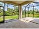Screened lanai featuring tile flooring and scenic backyard views at 12728 Richezza Dr, Venice, FL 34293