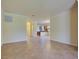 Living room flows into the kitchen, featuring tiled floors and neutral-toned walls at 12728 Richezza Dr, Venice, FL 34293