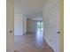 Spacious living room area featuring tiled floors, neutral wall color and entry to the screened lanai at 12728 Richezza Dr, Venice, FL 34293