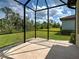 Screened-in patio featuring tile floors and an expansive view of the lush green backyard at 12728 Richezza Dr, Venice, FL 34293