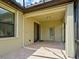 Covered patio with access to sliding doors that open up to the bright, sunny backyard at 12728 Richezza Dr, Venice, FL 34293