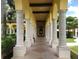 A charming walkway with arched columns and tiled flooring, ideal for a relaxing stroll at 12728 Richezza Dr, Venice, FL 34293