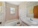 Full bathroom including a tub/shower combo, toilet and vanity with sink at 1316 Ridgewood Ave, Venice, FL 34285