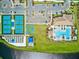 Overhead shot of community amenities, featuring a pool, pickleball courts, and parking at 13873 Karina St, Venice, FL 34293