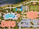 Birds eye view of community amenities: a pool, bocce ball, clubhouse, and parking surrounded by lush landscaping at 13873 Karina St, Venice, FL 34293