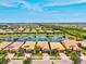 Beautiful aerial view of single-Gathering homes, landscaped yards, and waterfront in a residential neighborhood at 13873 Karina St, Venice, FL 34293