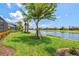 Lush green backyard with a beautiful water view, showcasing the serene landscape and outdoor space at 13873 Karina St, Venice, FL 34293