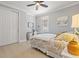 Cozy bedroom features neutral walls, ceiling fan, a double closet, and tiled flooring at 13873 Karina St, Venice, FL 34293