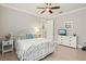 Bedroom with neutral walls, a ceiling fan, and tiled flooring, creating a calming and comfortable atmosphere at 13873 Karina St, Venice, FL 34293