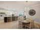 Bright dining area showcases the open floor plan with the living room and kitchen at 13873 Karina St, Venice, FL 34293