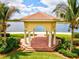 Picture of a beautiful gazebo overlooking a lake, surrounded by lush greenery and palm trees at 13873 Karina St, Venice, FL 34293
