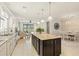 Open-concept kitchen with a large island, granite countertops and seamless flow into the living and dining spaces at 13873 Karina St, Venice, FL 34293