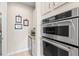 Stainless steel ovens and microwave built into cabinetry offer modern convenience and style at 13873 Karina St, Venice, FL 34293
