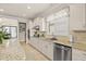 Well-lit kitchen featuring granite countertops, stainless steel appliances and ample cabinet space at 13873 Karina St, Venice, FL 34293