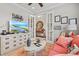 Cozy living room with a plush sofa, decorative rug, and an entertainment center with mounted television at 13873 Karina St, Venice, FL 34293