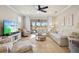 Bright and airy living room with patio access, neutral paint, and modern ceiling fan at 13873 Karina St, Venice, FL 34293