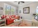 Bright living room featuring a comfortable sofa, large window, and stylish decor and furnishings at 13873 Karina St, Venice, FL 34293