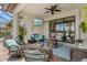 Covered patio featuring comfortable seating, a stone fire pit, and a mounted TV for outdoor relaxation at 13873 Karina St, Venice, FL 34293