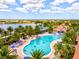 Community pool offering a recreational space and stunning overhead view of the community and landscape at 13873 Karina St, Venice, FL 34293