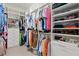 Spacious walk-in closet with custom shelving, drawers, and ample storage for clothes and accessories at 13873 Karina St, Venice, FL 34293