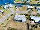 Aerial view of the home and fenced in yard, showing proximity to canal and boat docks at 140 Poinsettia Ne Cir, Port Charlotte, FL 33952