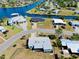 Aerial view of the home and surrounding neighborhood, situated on canal with boat access at 140 Poinsettia Ne Cir, Port Charlotte, FL 33952