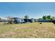 Large grassy backyard with black fence surrounding the perimeter, view to the back of the house at 140 Poinsettia Ne Cir, Port Charlotte, FL 33952
