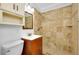 Bathroom featuring a tiled shower with decorative accents and a wood vanity at 140 Poinsettia Ne Cir, Port Charlotte, FL 33952