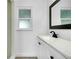 Bathroom features a black faucet, vanity, and a bright window at 140 Poinsettia Ne Cir, Port Charlotte, FL 33952