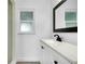 Bathroom featuring a black faucet, vanity and ample natural light at 140 Poinsettia Ne Cir, Port Charlotte, FL 33952